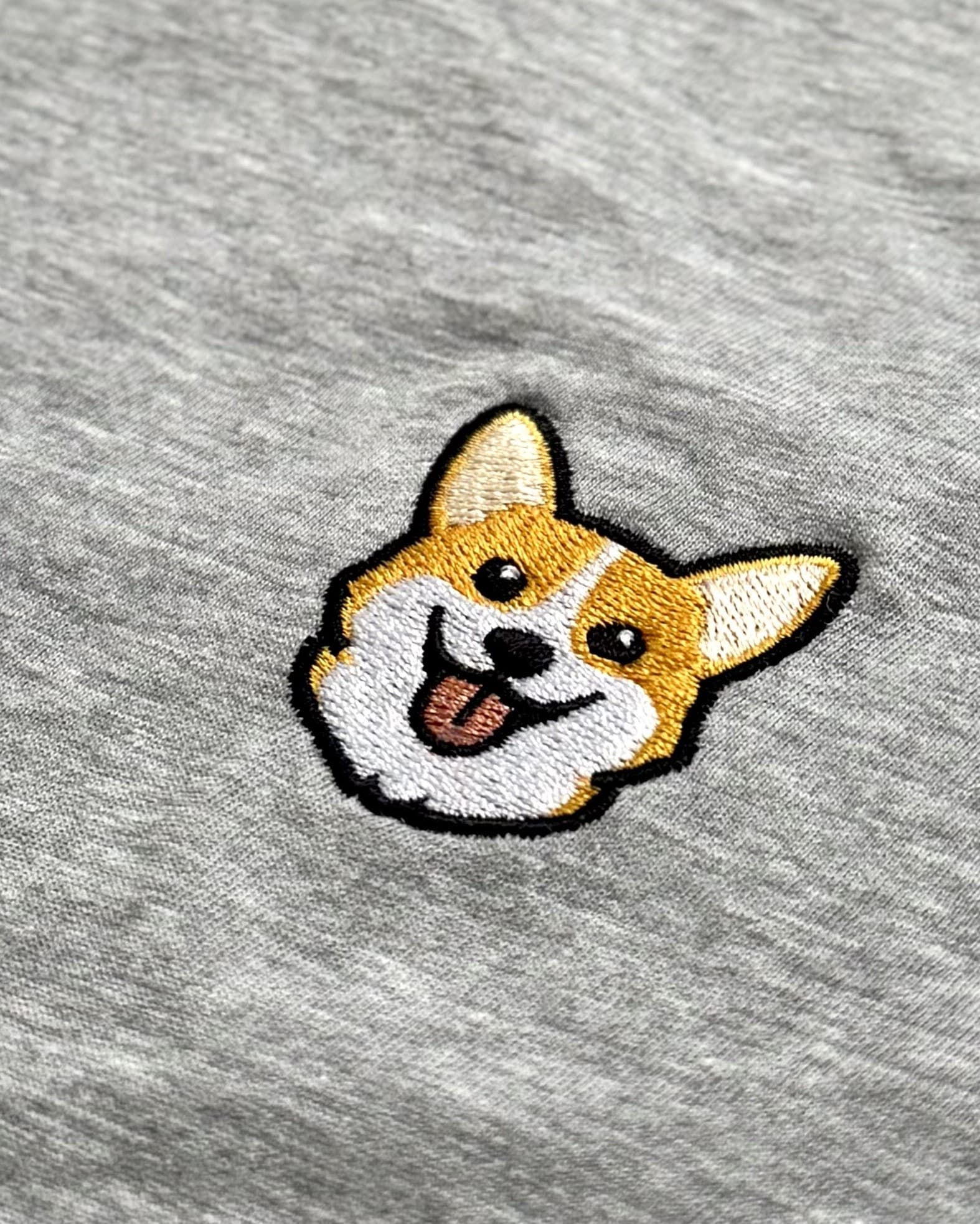 Close-up detail of Corgi embroidery on Light Grey Heather fabric showing stitch texture.