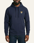 Man wearing Navy Hoodie with minimalist embroidered Corgi icon on left chest.