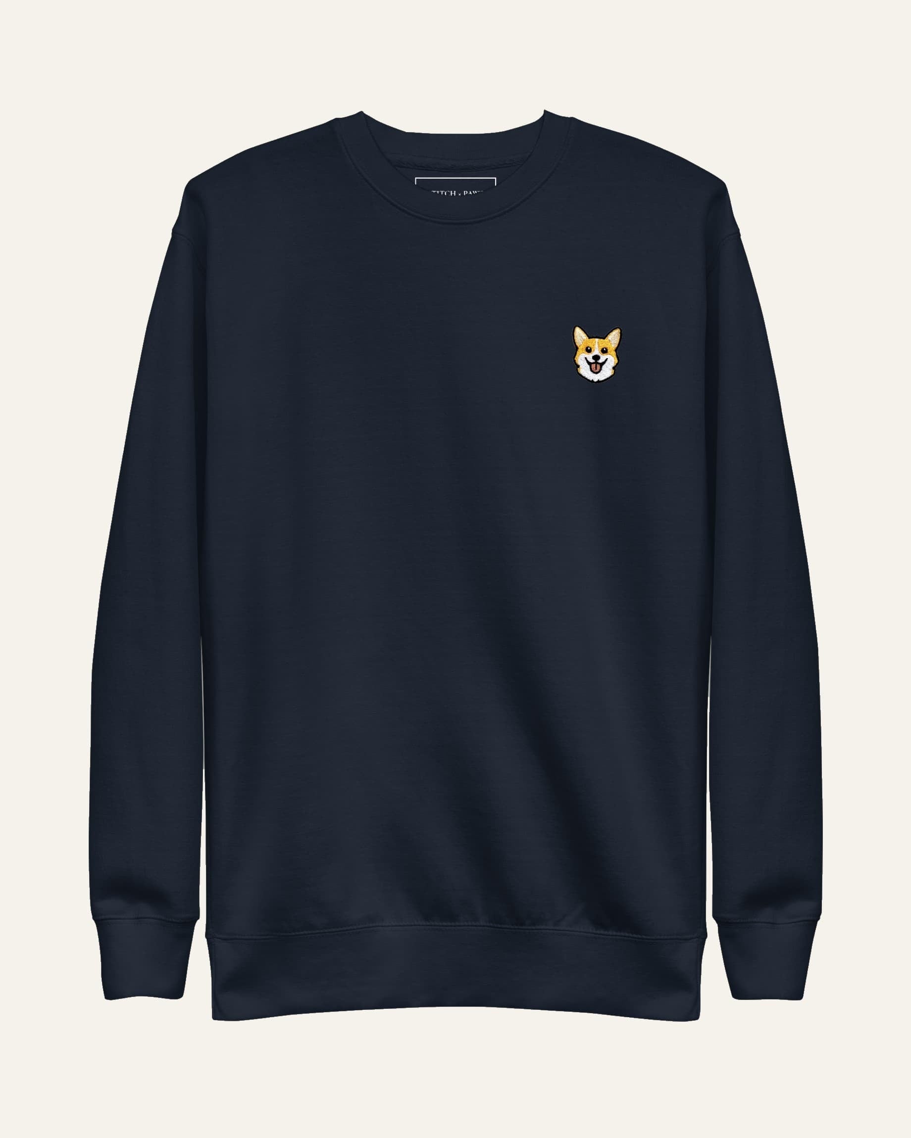 Navy Sweatshirt with minimalist embroidered Corgi icon on left chest.