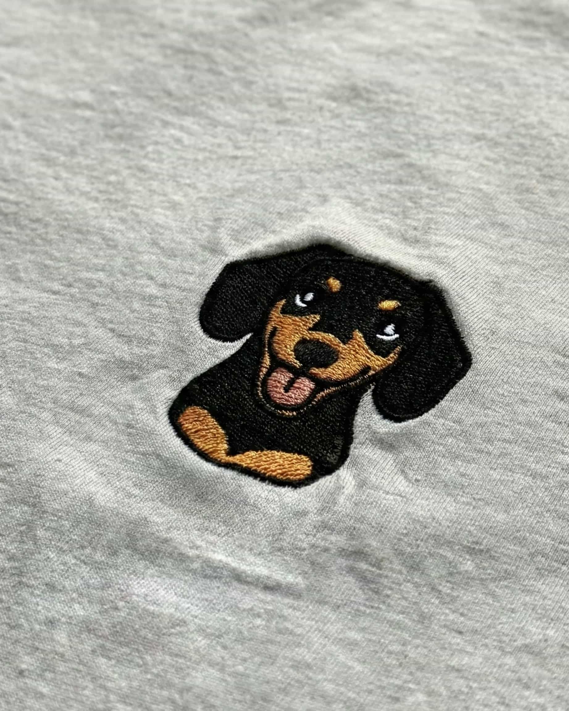 Close-up detail of Dachshund embroidery on Light Grey Heather fabric showing stitch texture.