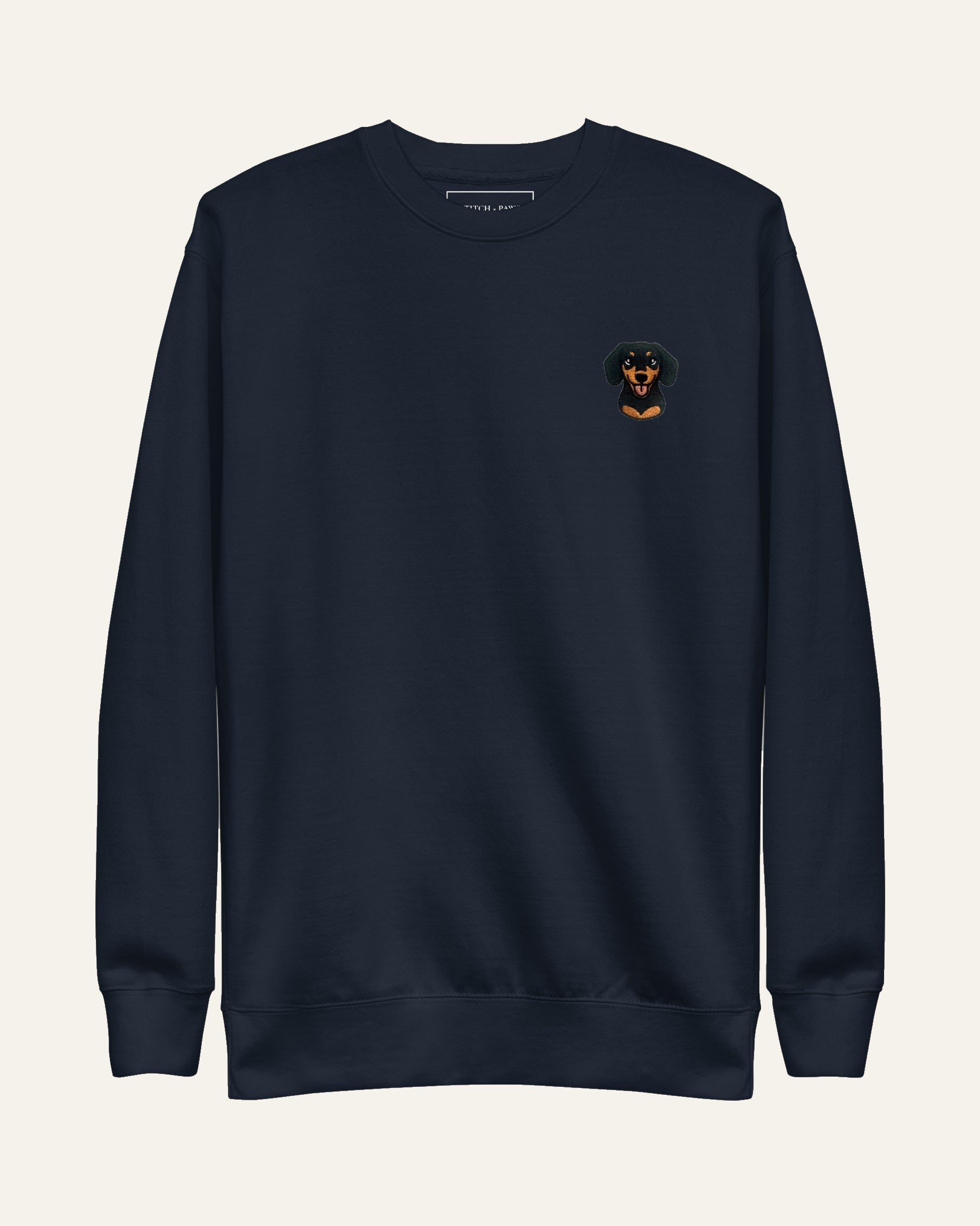 Navy Sweatshirt with minimalist embroidered Dachshund icon on left chest.