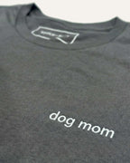 Close up of Asphalt  t-shirt with minimalist embroidered phrase "dog mom" on left chest.