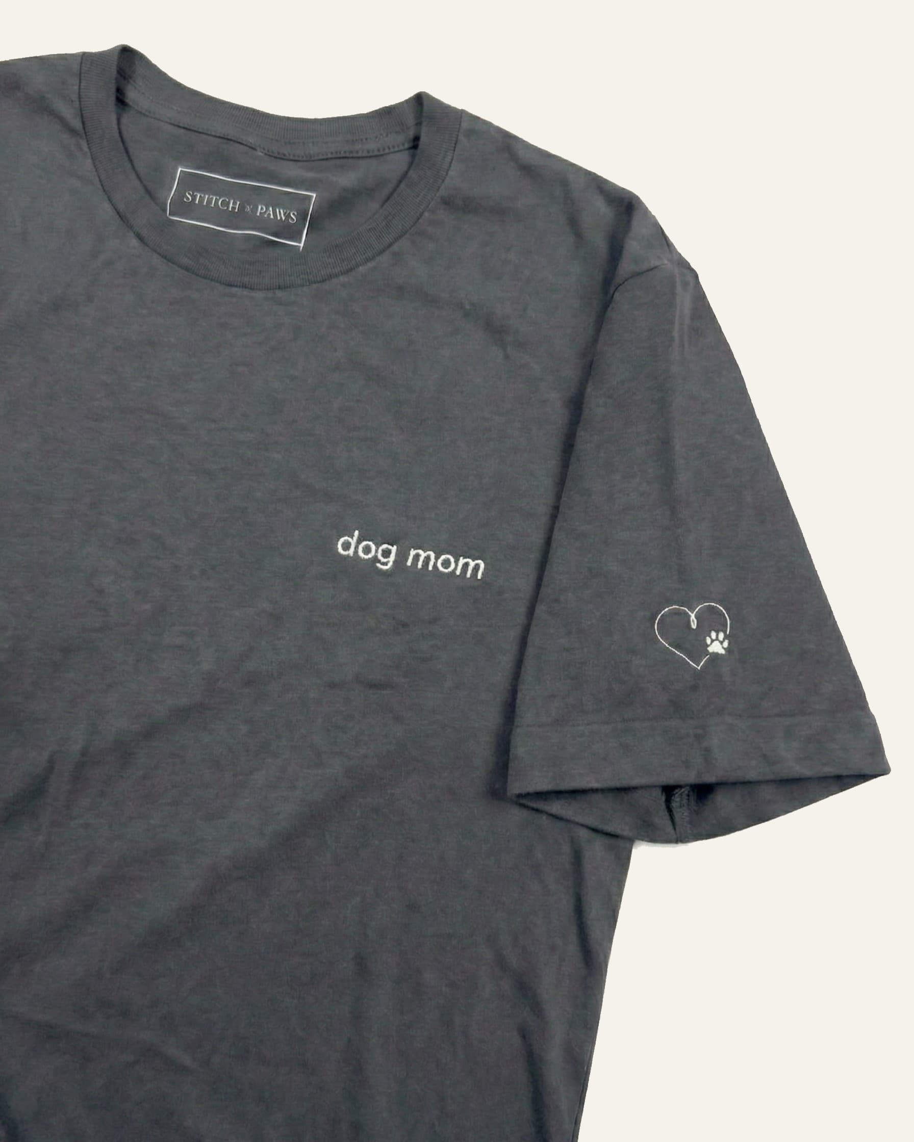 Asphalt t-shirt with minimalist embroidered phrase "dog mom" on left chest. Embroidered Heart and Paw icon on the left sleeve above cuff.