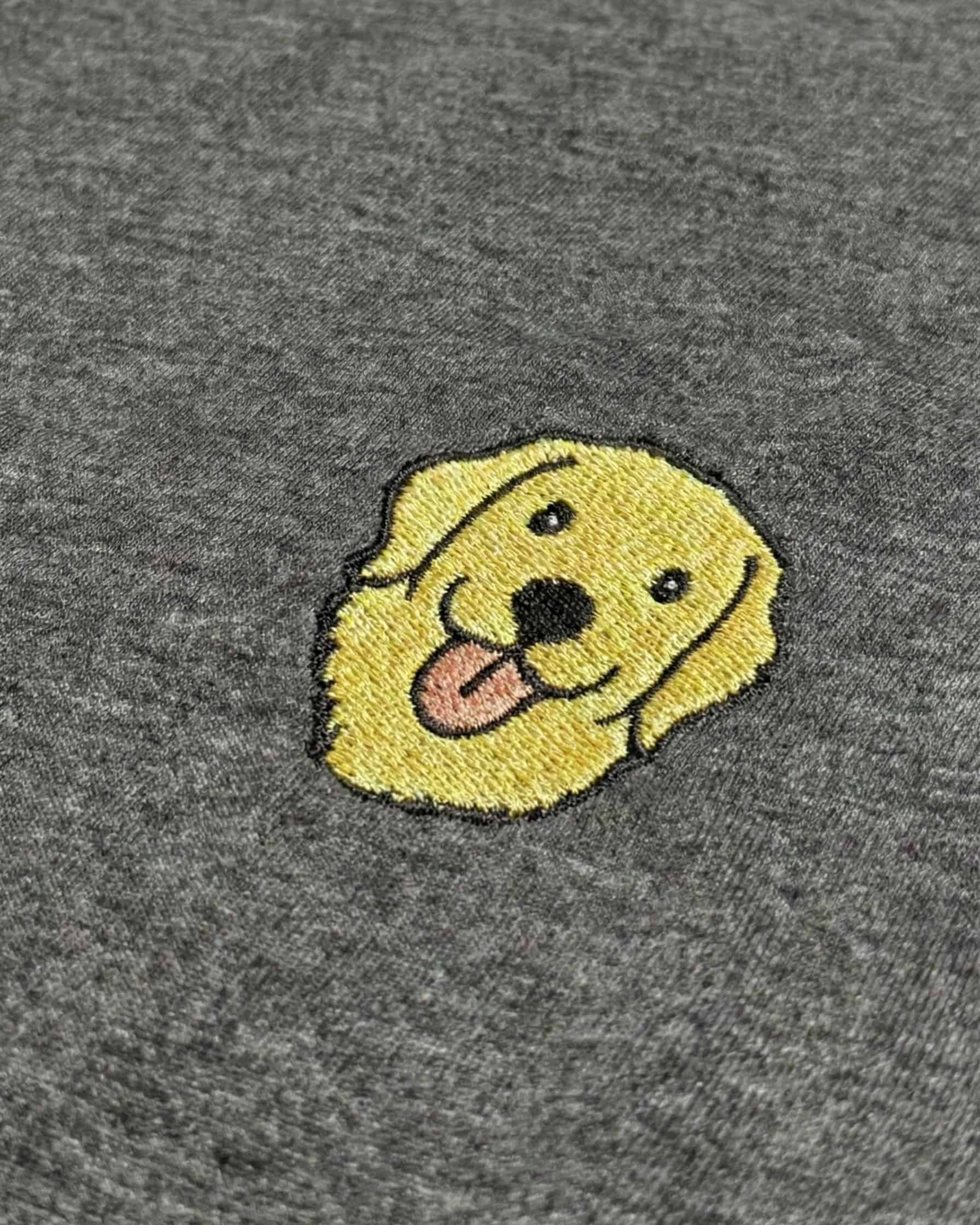 Close-up detail of Golden Retriever embroidery on Dark Grey Heather fabric showing stitch texture.