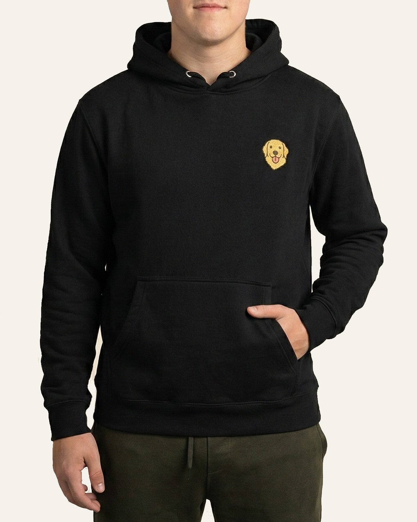 Man wearing Black Hoodie with minimalist embroidered Golden Retriever icon on left chest.