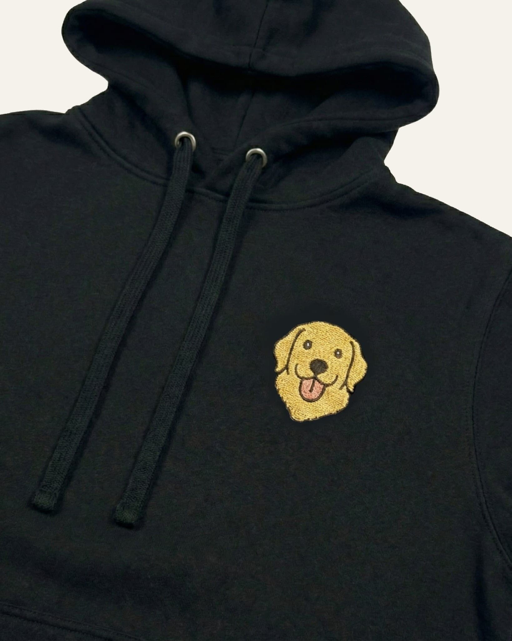 Black Hoodie with minimalist embroidered Golden Retriever icon on left chest.