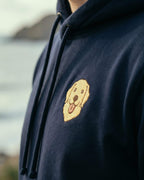 Close-up detail of Golden Retriever embroidery on navy fabric showing stitch texture.