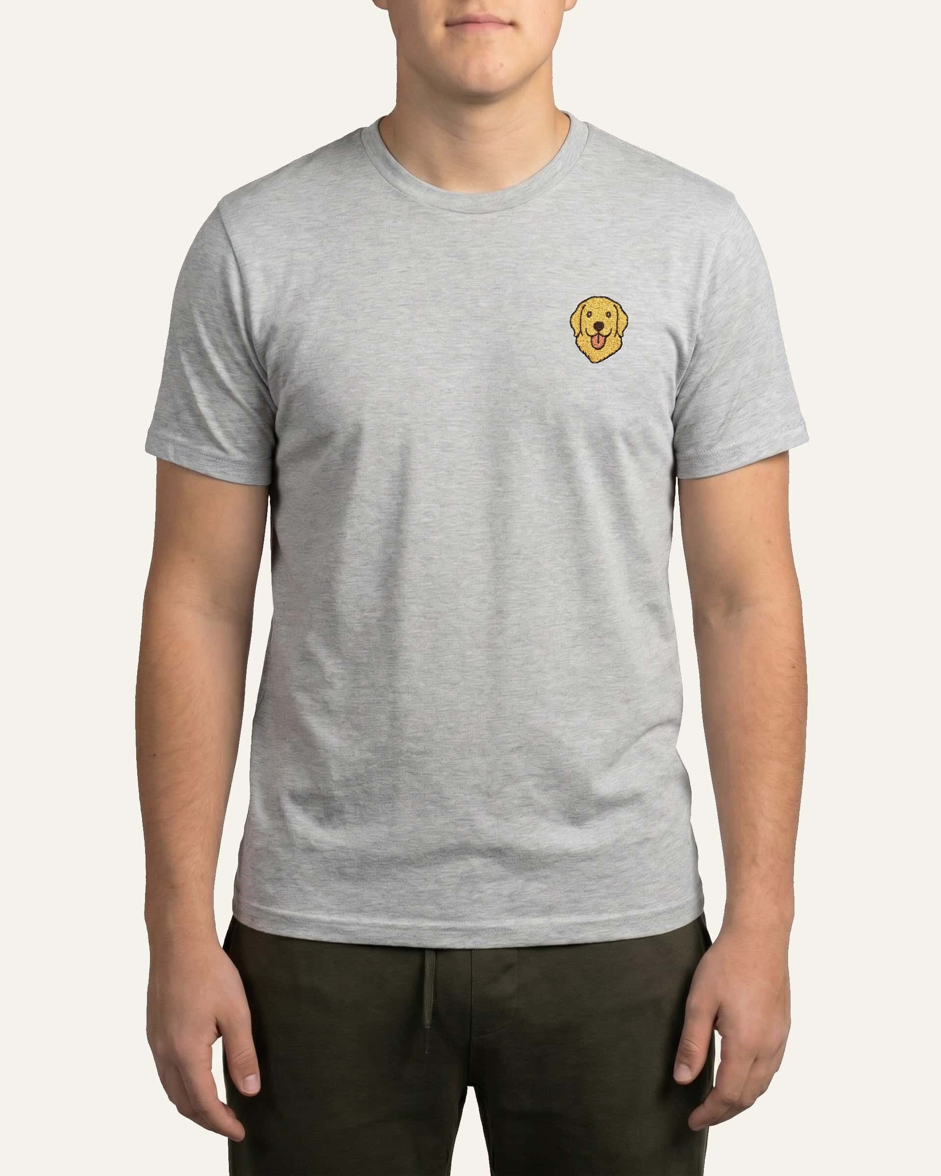 Man wearing Light Grey Heather T-shirt with minimalist embroidered Golden Retriever icon on left chest.