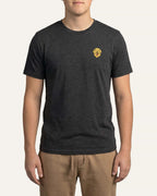 Man wearing Dark Grey Heather T-shirt with minimalist embroidered Golden Retriever icon on left chest.