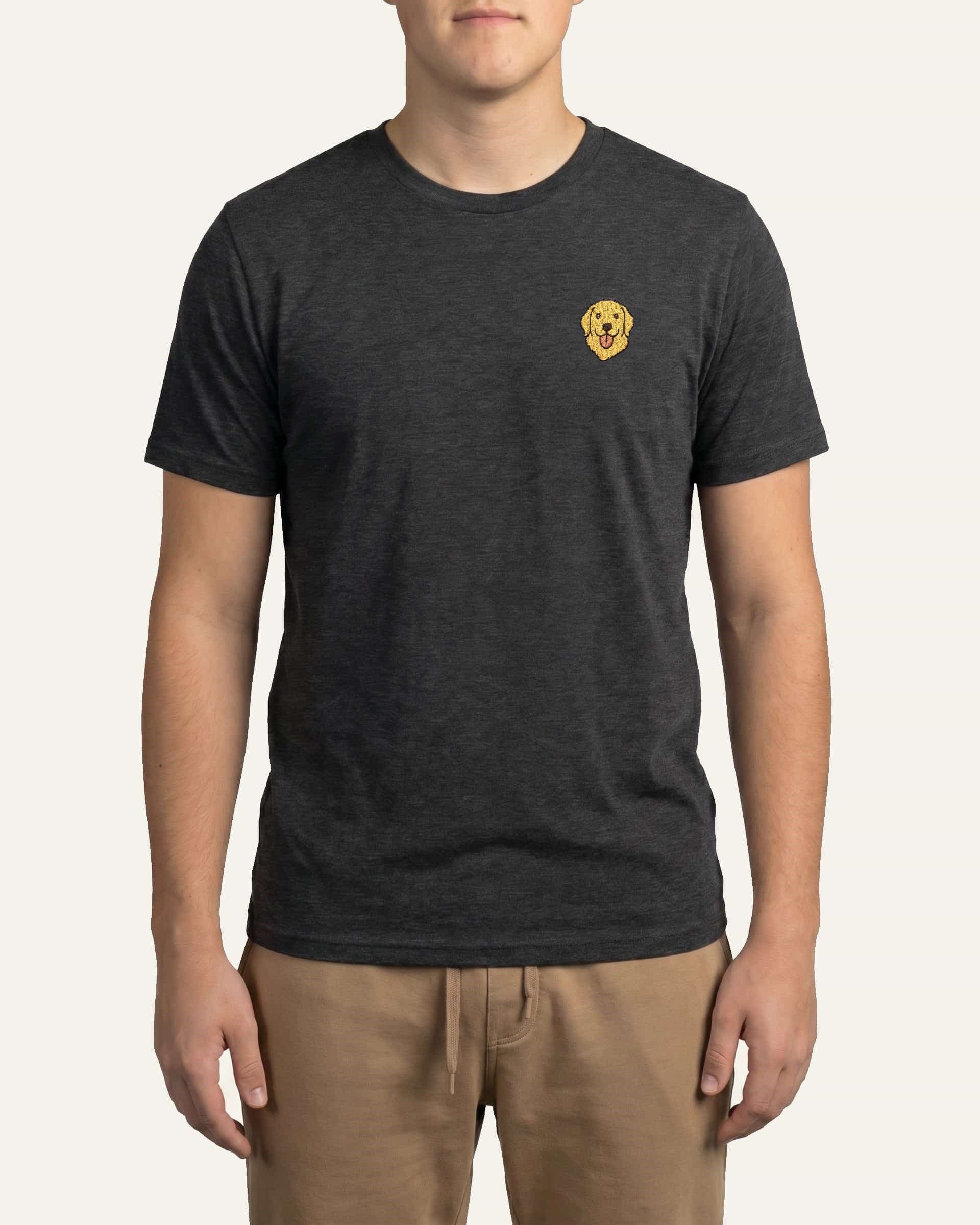 Man wearing Dark Grey Heather T-shirt with minimalist embroidered Golden Retriever icon on left chest.