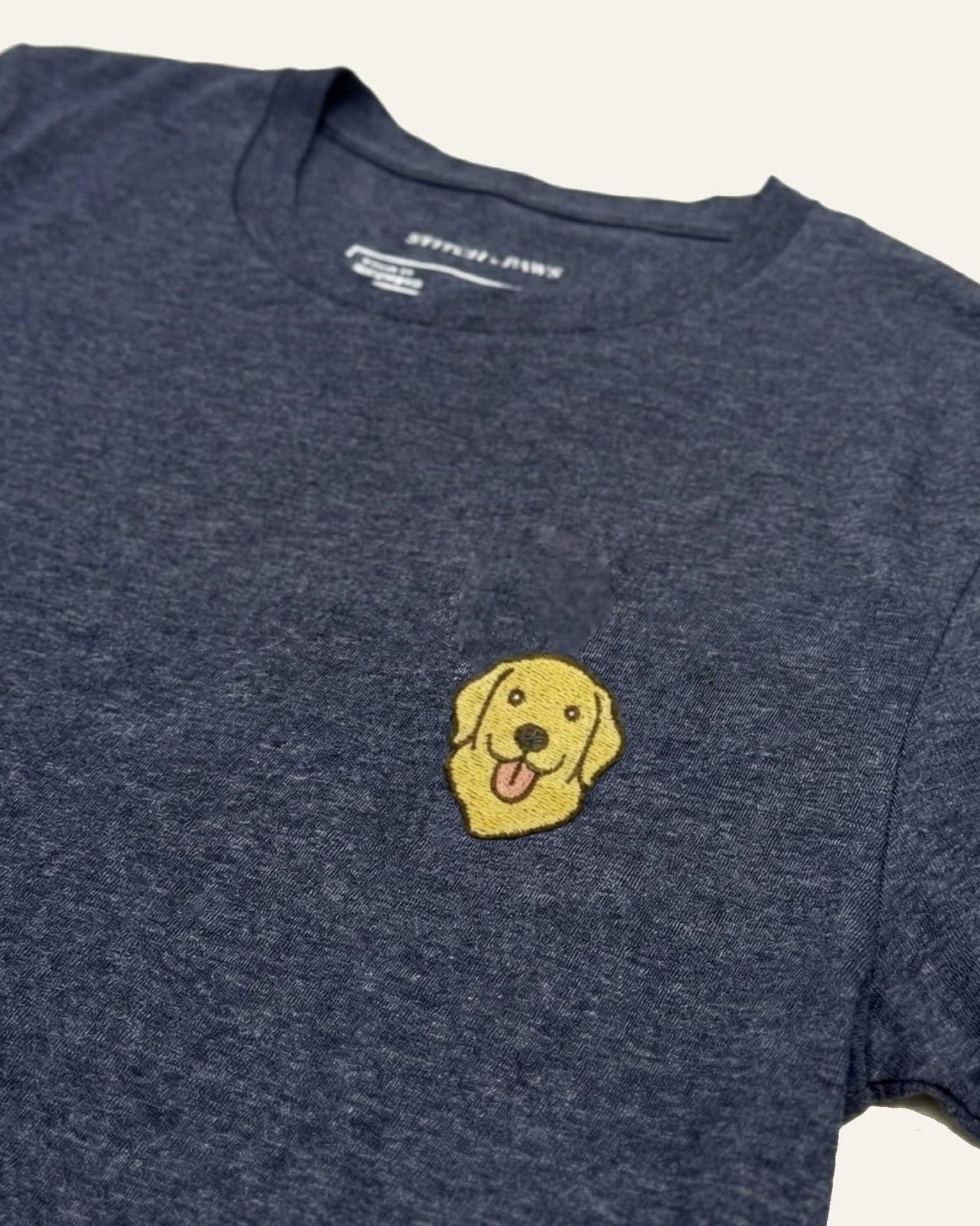 Midnight Navy Heather T-shirt with minimalist embroidered Golden Retriever icon on left chest.