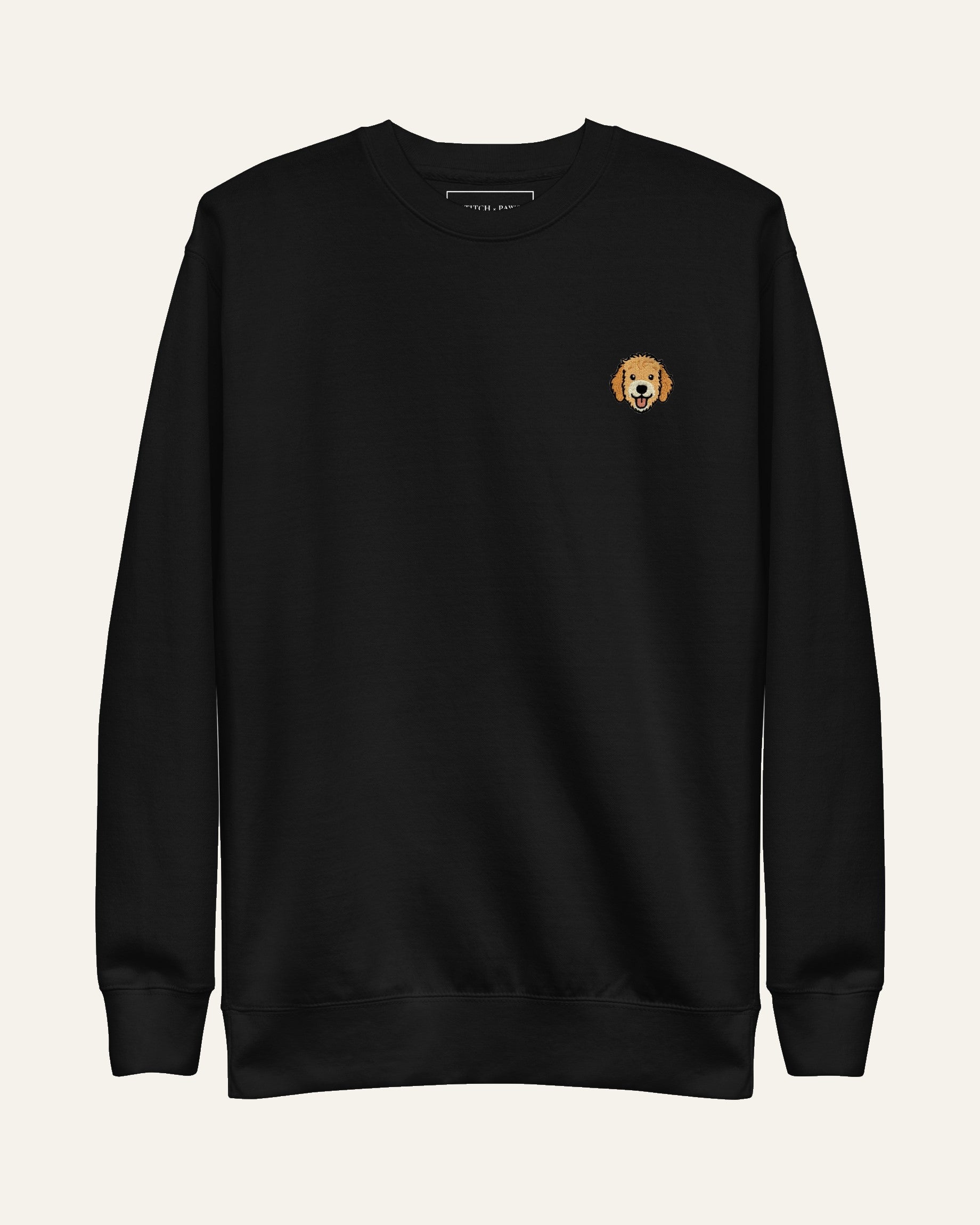 Black Sweatshirt with minimalist embroidered Goldendoodle icon on left chest.