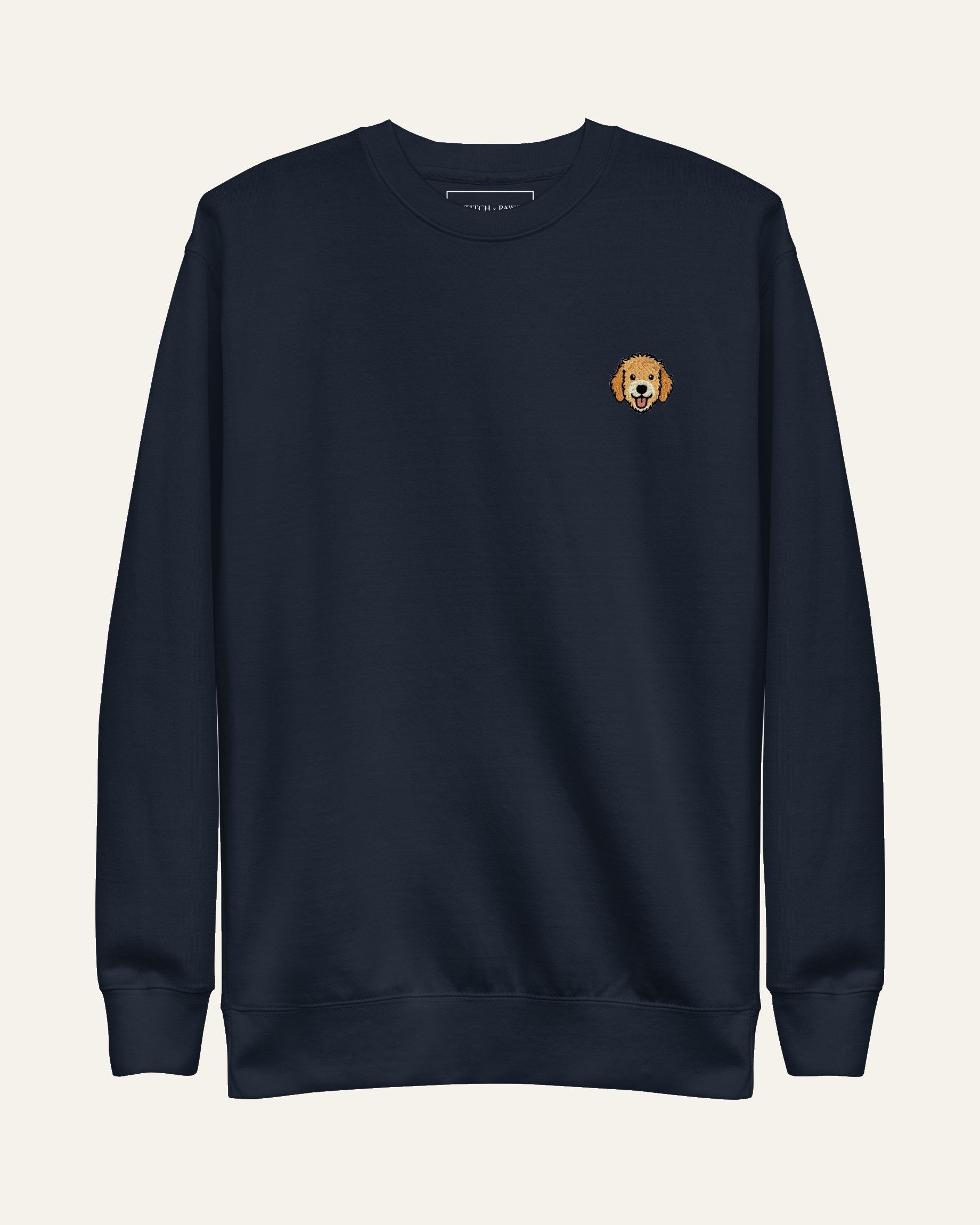 Navy Sweatshirt with minimalist embroidered Goldendoodle icon on left chest.