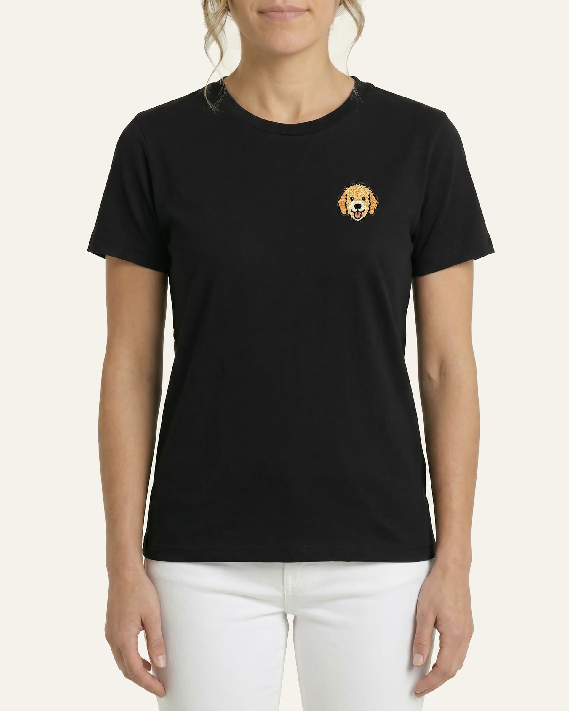 Woman wearing Black T-shirt with minimalist embroidered Goldendoodle icon on left chest.