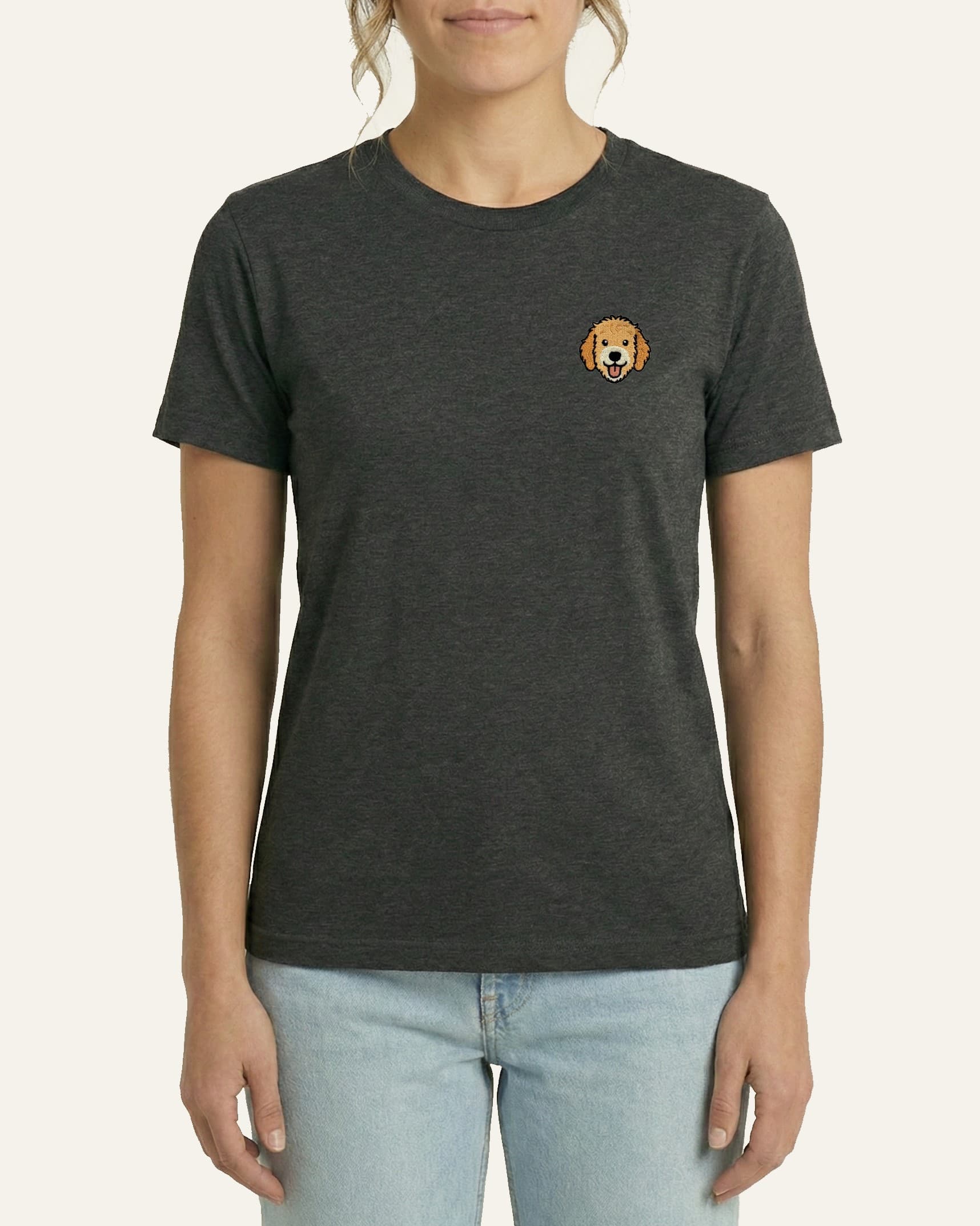 Woman wearing Dark Grey Heather T-shirt with minimalist embroidered Goldendoodle icon on left chest.