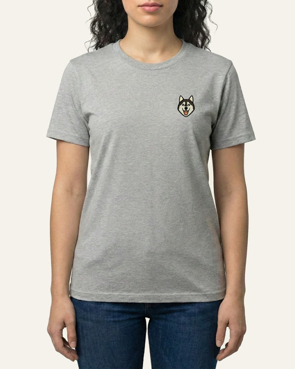 Woman wearing Light Grey Heather T-shirt with minimalist embroidered Husky icon on left chest.
