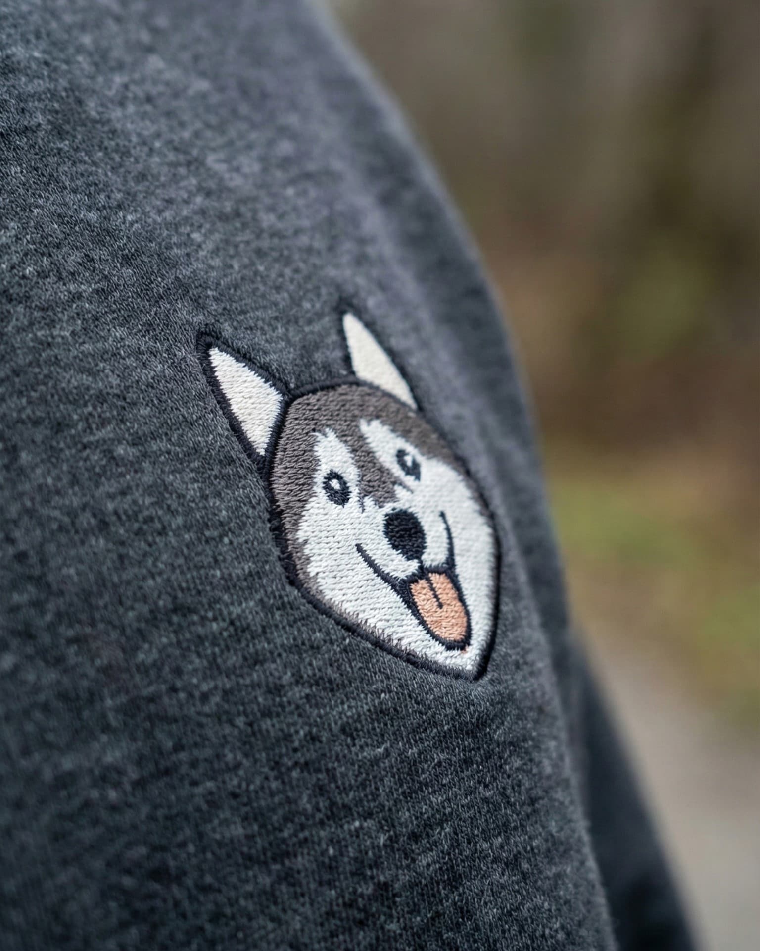 Close-up detail of Husky embroidery on Dark Grey Heather fabric showing stitch texture.