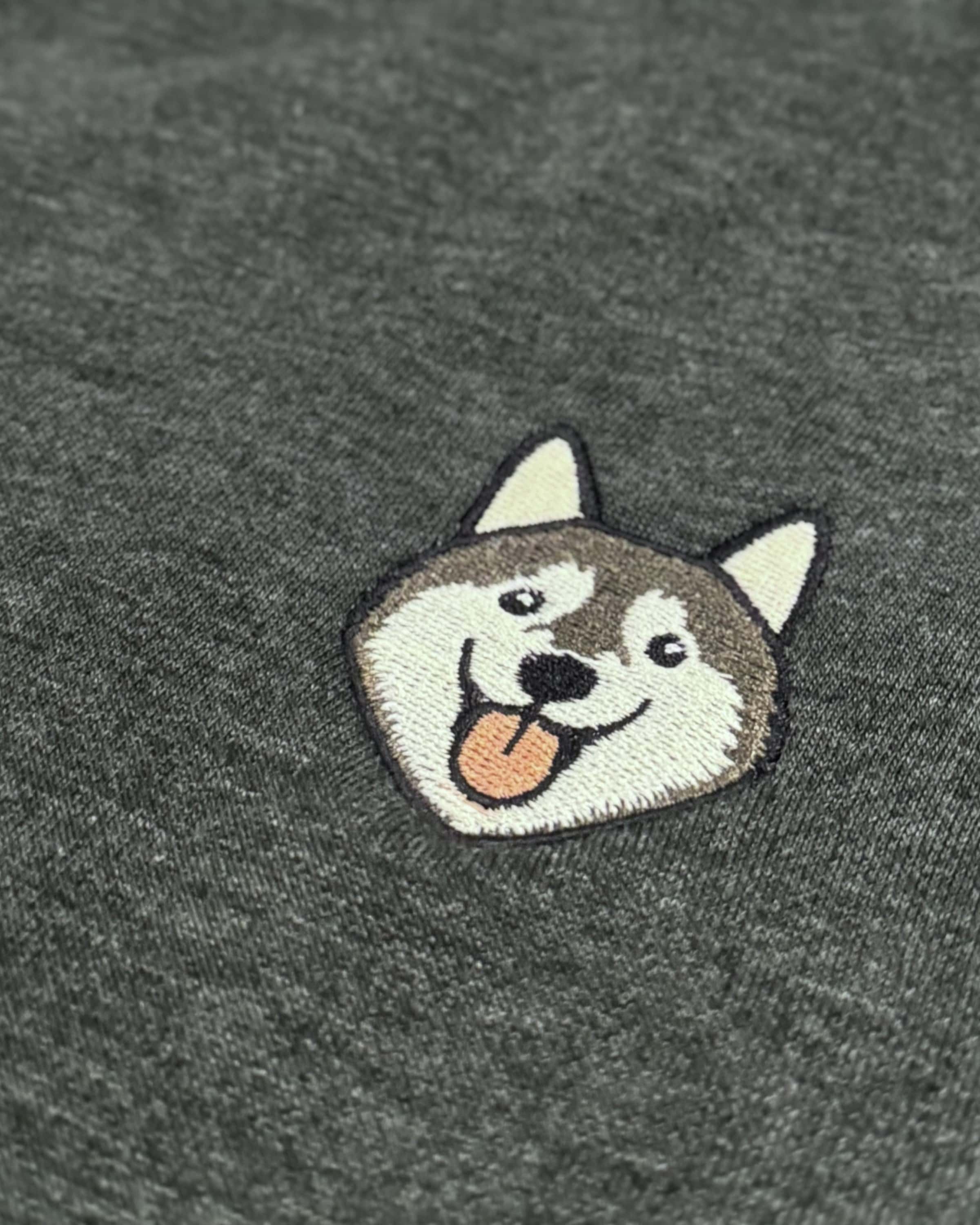 Close-up detail of Husky embroidery on Dark Grey Heather fabric showing stitch texture.