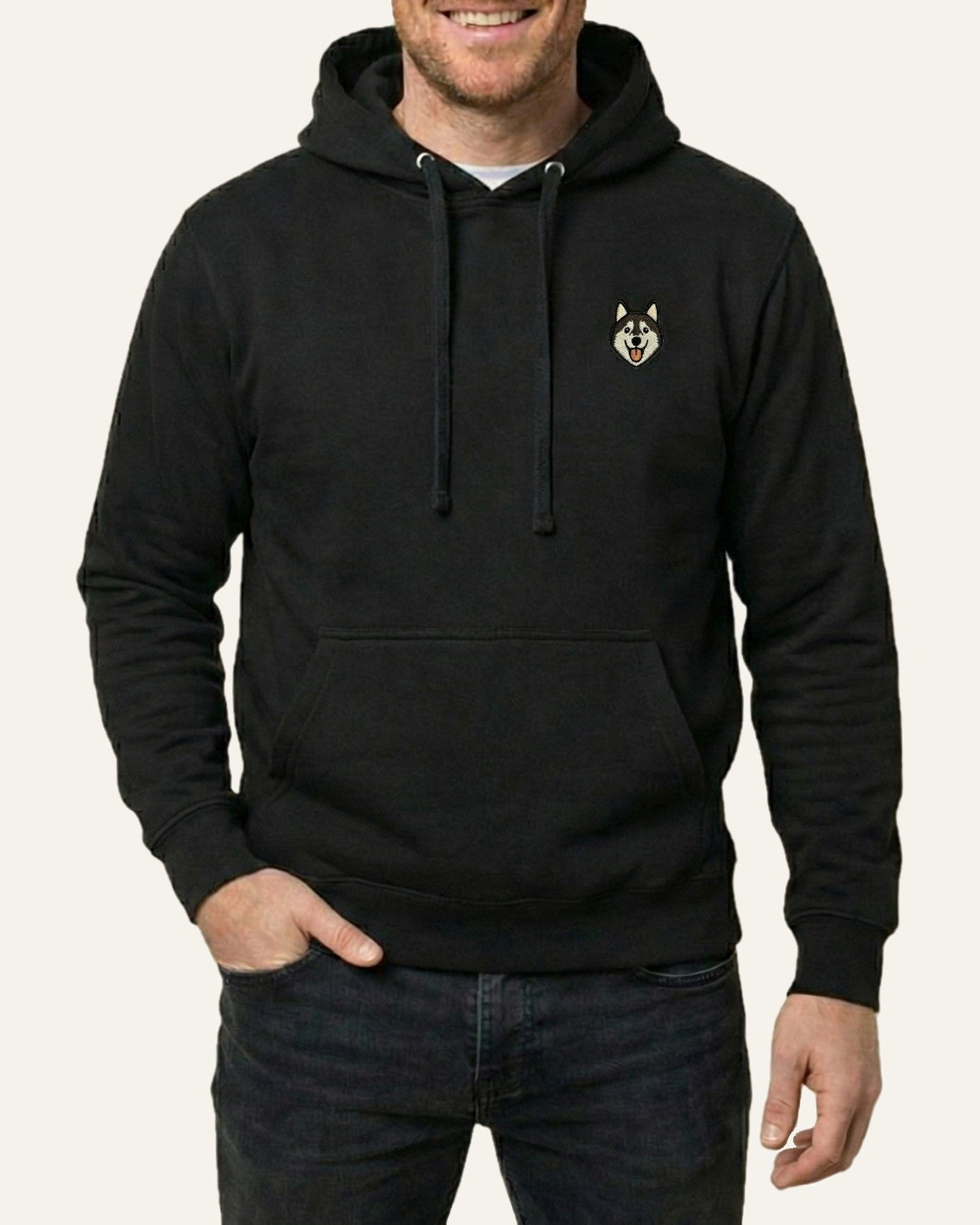 Man wearing Black Hoodie with minimalist embroidered Husky icon on left chest.