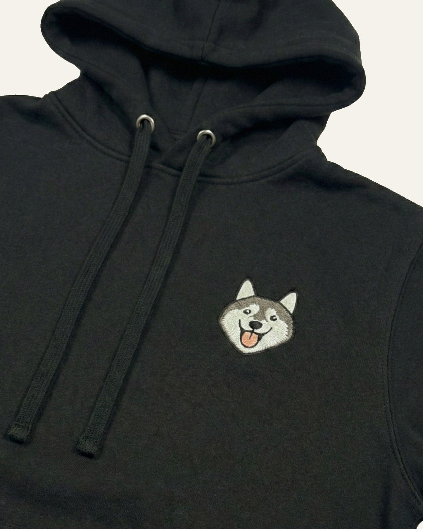 Black Hoodie with minimalist embroidered Husky icon on left chest.