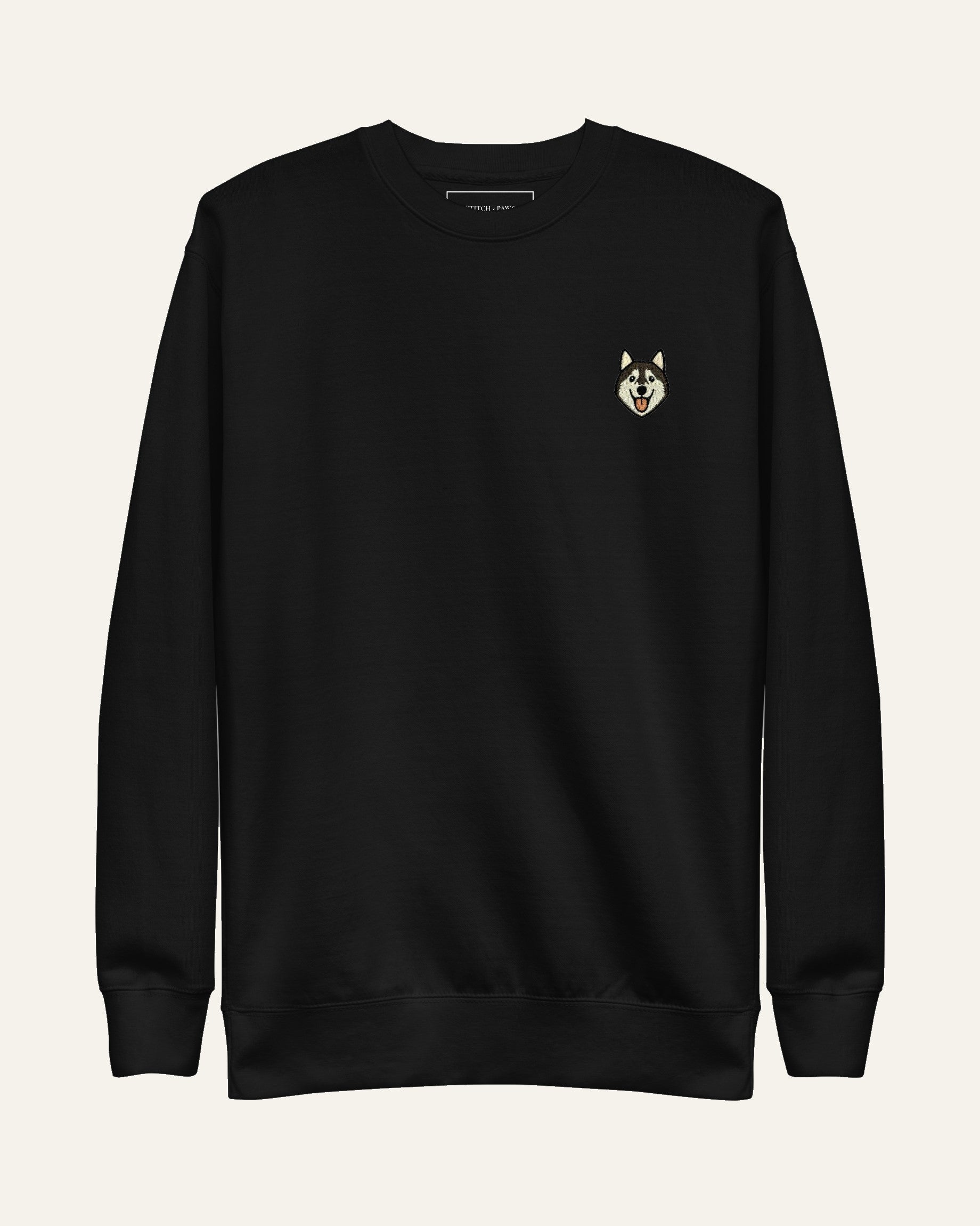 Black Sweatshirt with minimalist embroidered Husky icon on left chest.