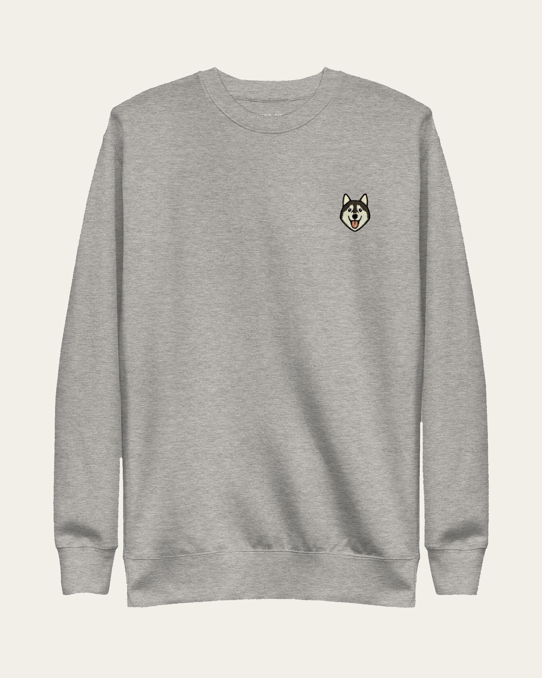 Light Grey Heather Sweatshirt with minimalist embroidered Husky icon on left chest.