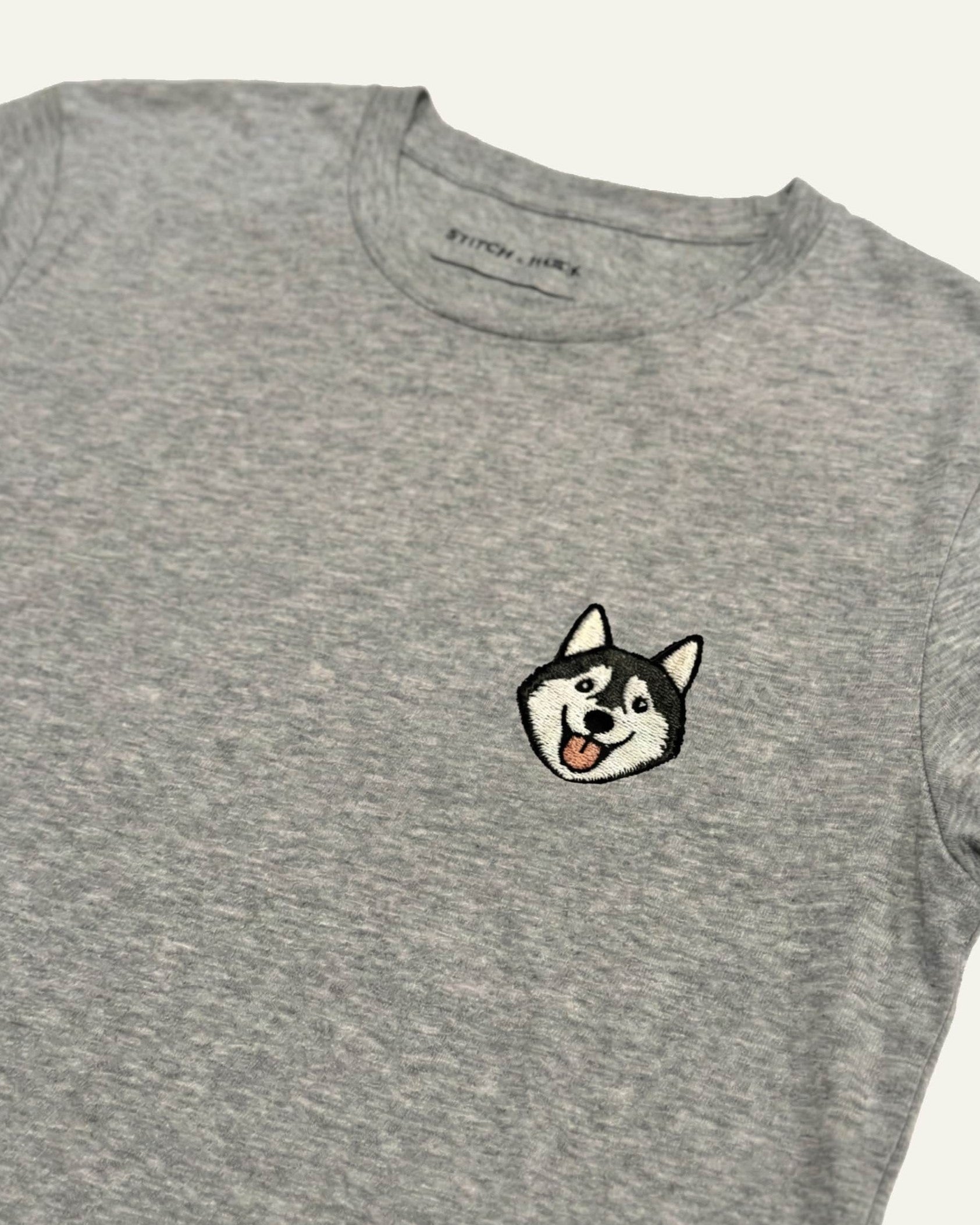 Light Grey Heather T-shirt with minimalist embroidered Husky icon on left chest.