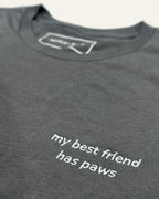 Close up of Asphalt t-shirt with minimalist embroidered phrase "my best friend has paws" on left chest. 