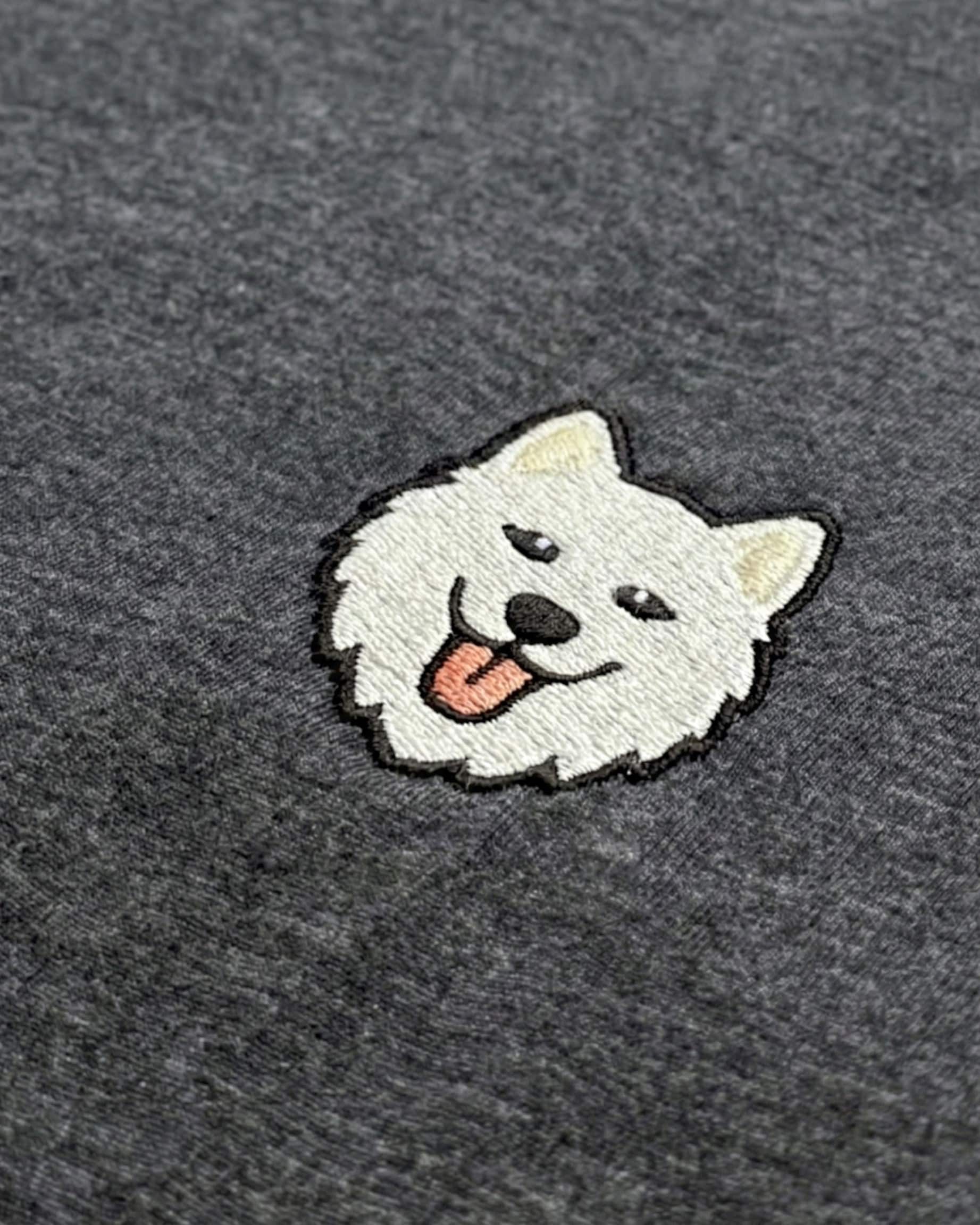 Close-up detail of Samoyed embroidery on Dark Grey Heather fabric showing stitch texture.