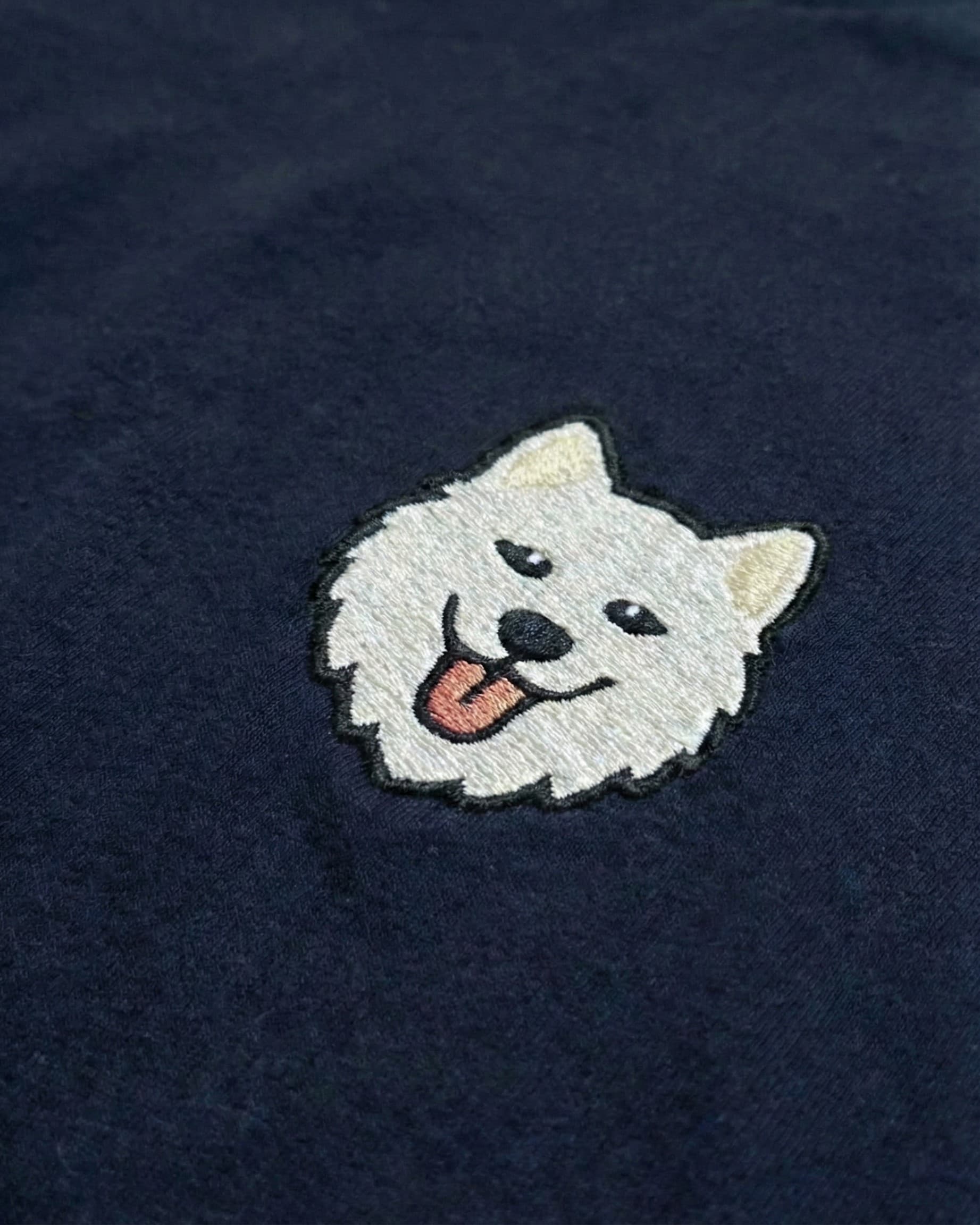 Close-up detail of Samoyed embroidery on Navy fabric showing stitch texture.