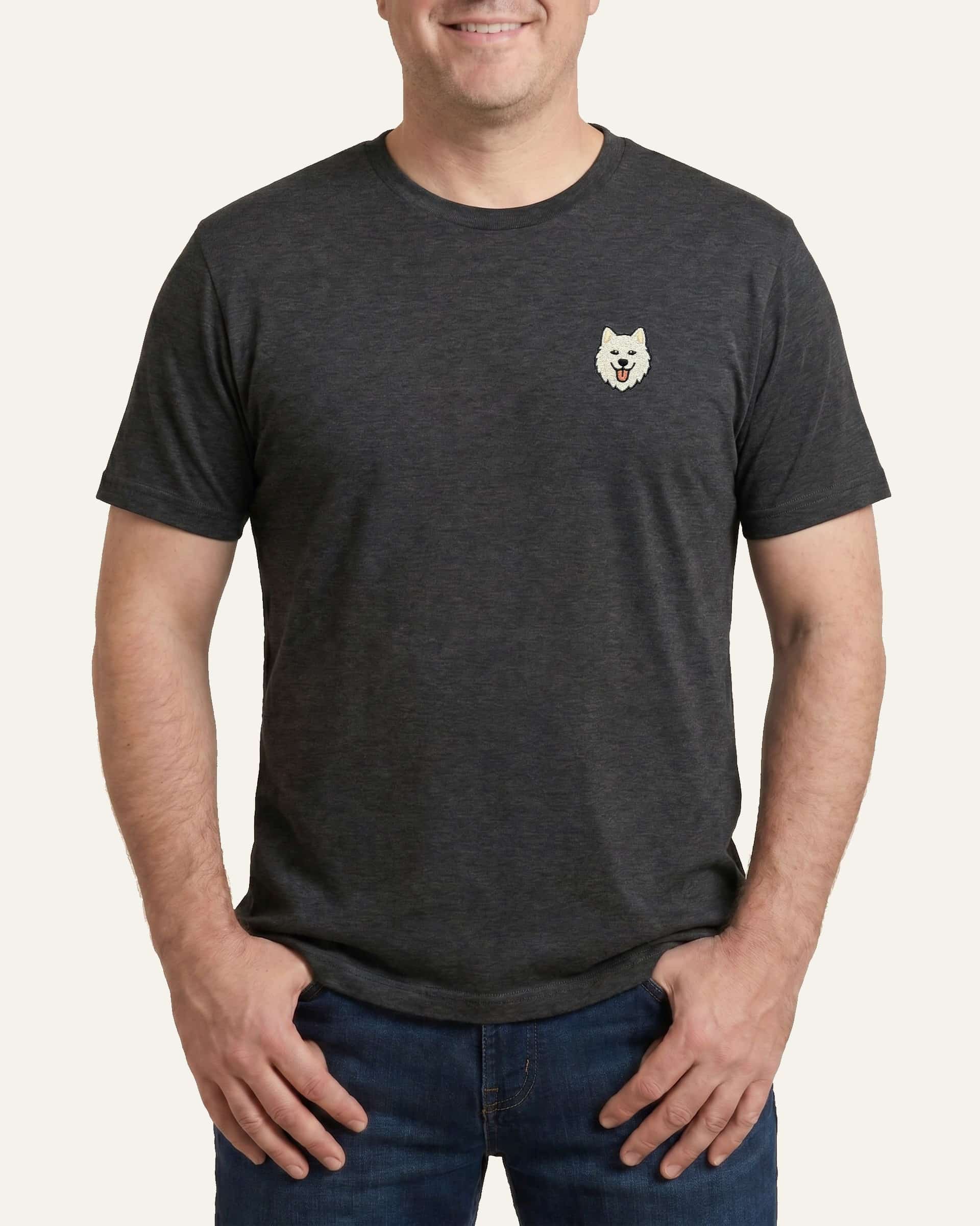 Man wearing Dark Grey Heather T-shirt with minimalist embroidered Samoyed icon on left chest.
