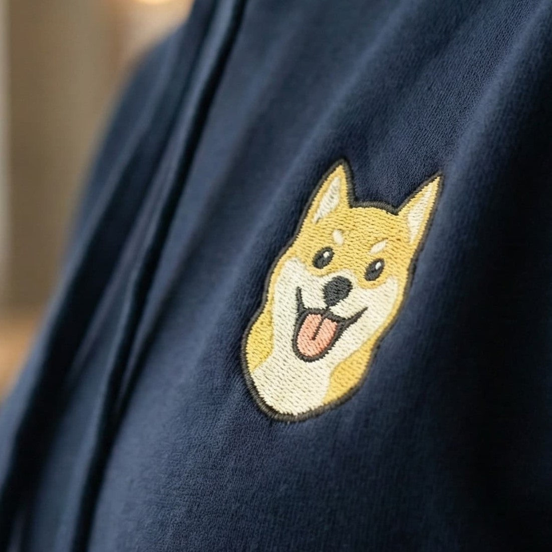 Close-up detail of Shiba Inu embroidery on Navy Hoodie showing stitch texture.