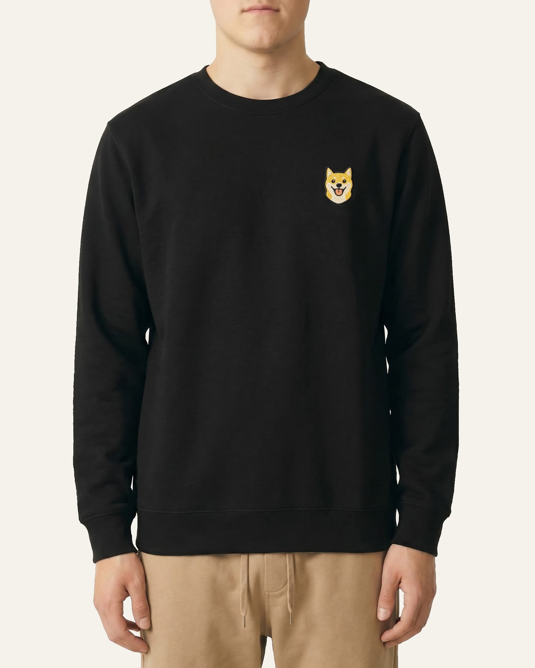 Man wearing Black Sweatshirt with minimalist embroidered Shiba Inu icon on left chest.