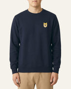 Man wearing Navy Sweatshirt with minimalist embroidered Shiba Inu icon on left chest.