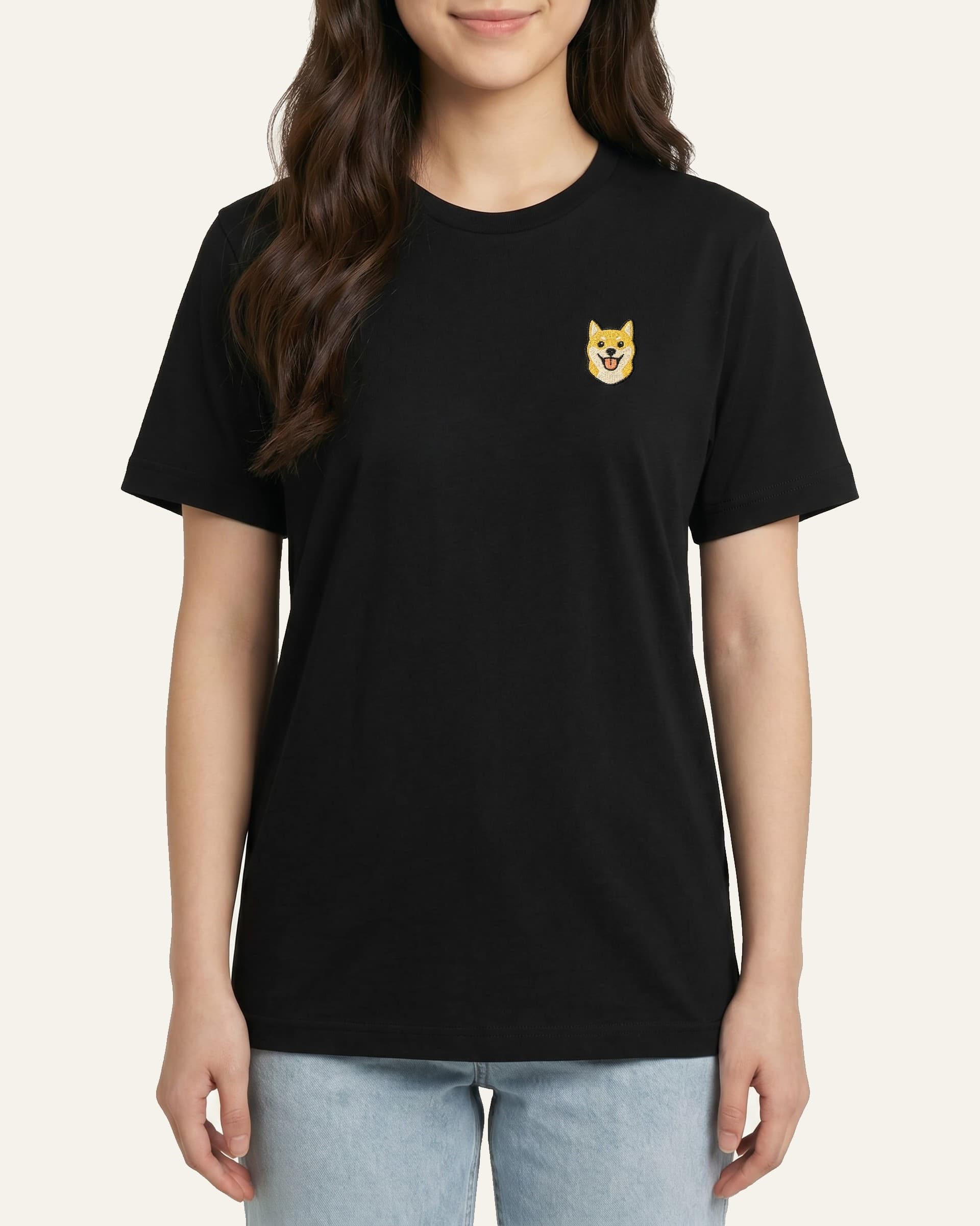Woman wearing Black T-shirt with minimalist embroidered Shiba Inu icon on left chest.