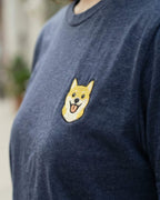 Close-up detail of Shiba Inu embroidery on navy heather fabric showing stitch texture.