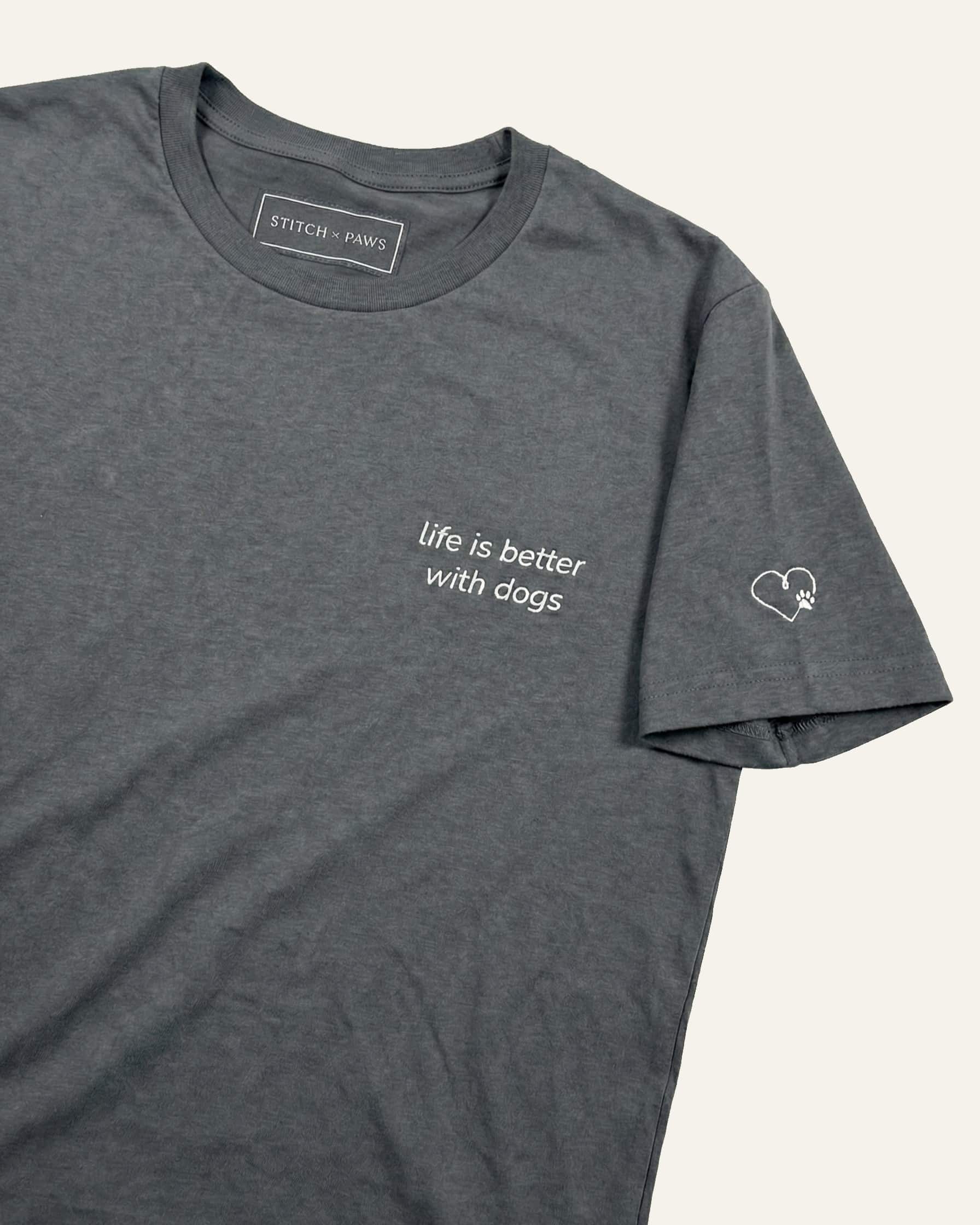 Asphalt t-shirt with minimalist embroidered phrase "life is better with dogs" on left chest. Embroidered Heart and Paw icon on the left sleeve above cuff.